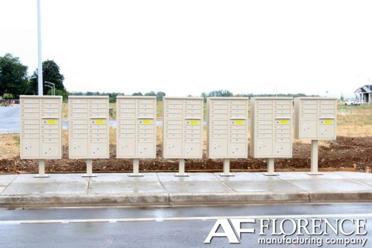 Row of pedestal-mounted cluster box units along a residential sidewalk
